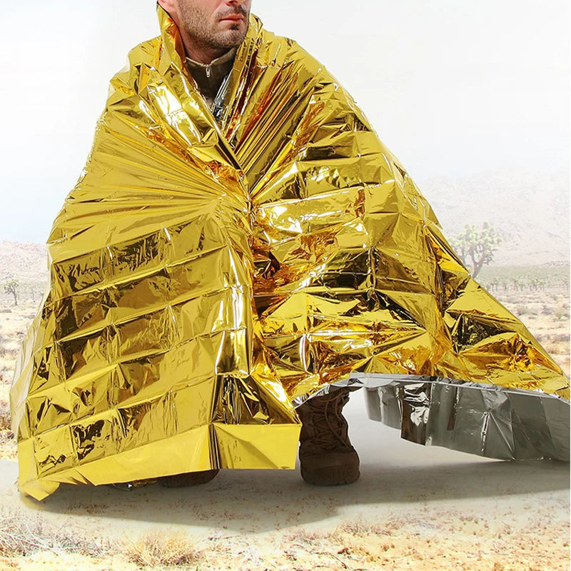 Outdoor Emergency Survival First Aid Rescue Kit featuring a Windproof, Waterproof Thermal Foil Blanket ideal for Camping and Hiking.